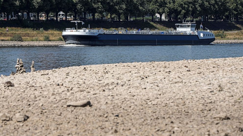 The river Rhine is pictured with low water in Cologne, Germany, Wednesday, Aug. 10, 2022. The low water levels are threatening Germany's industry as more and more ships are unable to traverse the key waterway. Severe drought will worsen in Europe in 
