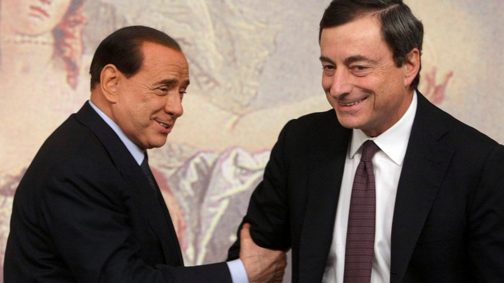 FILE - Former and present Italian Premiers Silvio Berlusconi, left, and Mario Draghi, right, are seen during a press conference at Chigi Palace,in Rome, on Oct. 8, 2008. Italy’s lower chamber of parliament on Tuesday set Jan. 24 as the start date to 