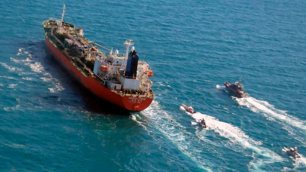 FILE - In this Monday, Jan. 4, 2021 file photo released by Tasnim News Agency, a seized South Korean-flagged tanker is escorted by Iranian Revolutionary Guard boats on the Persian Gulf. Iranian state television acknowledged that Tehran seized the oil