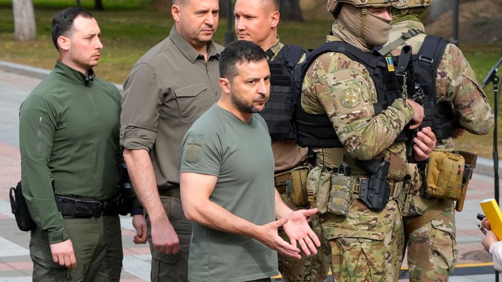 Ukrainian President Volodymyr Zelenskyy, center, reacts after his press conference in Kyiv, Ukraine, Friday, Sept. 9, 2022. (AP Photo/Efrem Lukatsky)