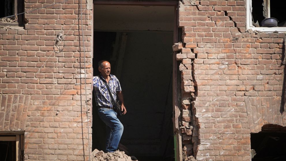 Local resident stands in a building destroyed during a missile strike in Kharkiv, Ukraine, Thursday, Aug. 18, 2022. (AP Photo/Andrii Marienko)