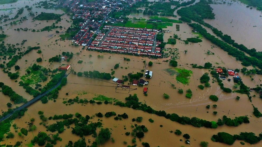 Aerial view of floods caused by heavy rains in the city of Itapetinga, southern region of the state of Bahia, Brazil, Sunday, Dec. 26, 2021. The Bahia state government's press office said heavy rains have caused floods that have killed 18 people and 