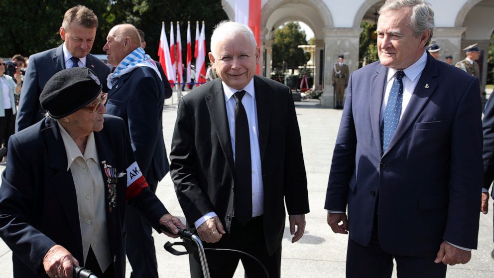 Poland's main ruling party leader Jaroslaw Kaczynski, center, attends a wreath laying ceremony marking national observances of the anniversary of World War II in Warsaw, Poland, Sept. 1, 2022. World War II began on Sept. 1, 1939, with Nazi Germany's 