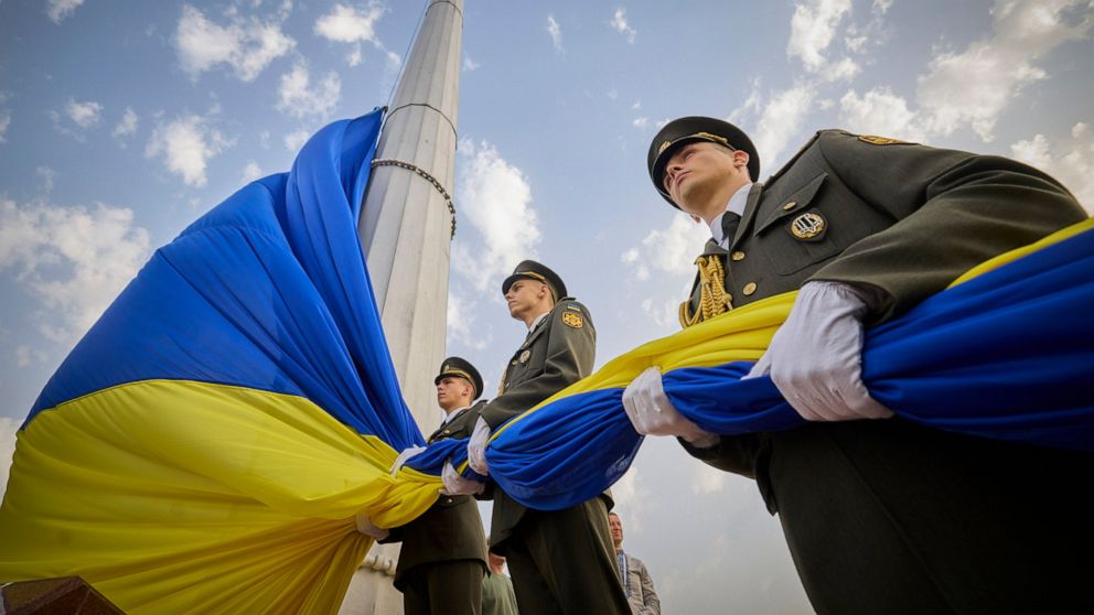 In this photo provided by the Ukrainian Presidential Press Office, honour guard soldiers prepare to rise the Ukrainian national flag during State Flag Day celebrations in Kyiv, Ukraine, Tuesday, Aug. 23, 2022. (Ukrainian Presidential Press Office via AP)