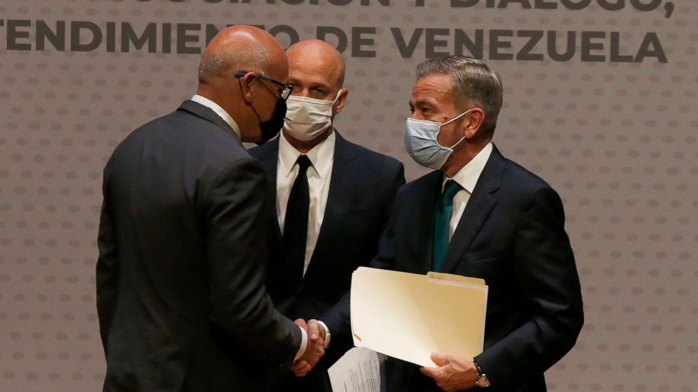 FILE - Venezuelan President of the National Assembly Jorge Rodriguez, left, shakes hands with Venezuelan opposition delegate Gerardo Blyde Perez in Mexico City, Aug. 13, 2021. The government of Venezuelan President Nicolás Maduro and representatives 