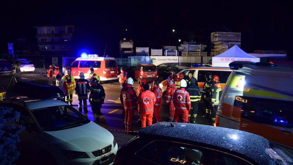 Emergency services of the Luttach voluntary fire brigade secure an accident site after a car drove into a group of people crossing a road in Luttach, near Bruneck in the northern region South Tirol, Italy, on early Sunday, Jan. 5, 2020. (Freiwillige 