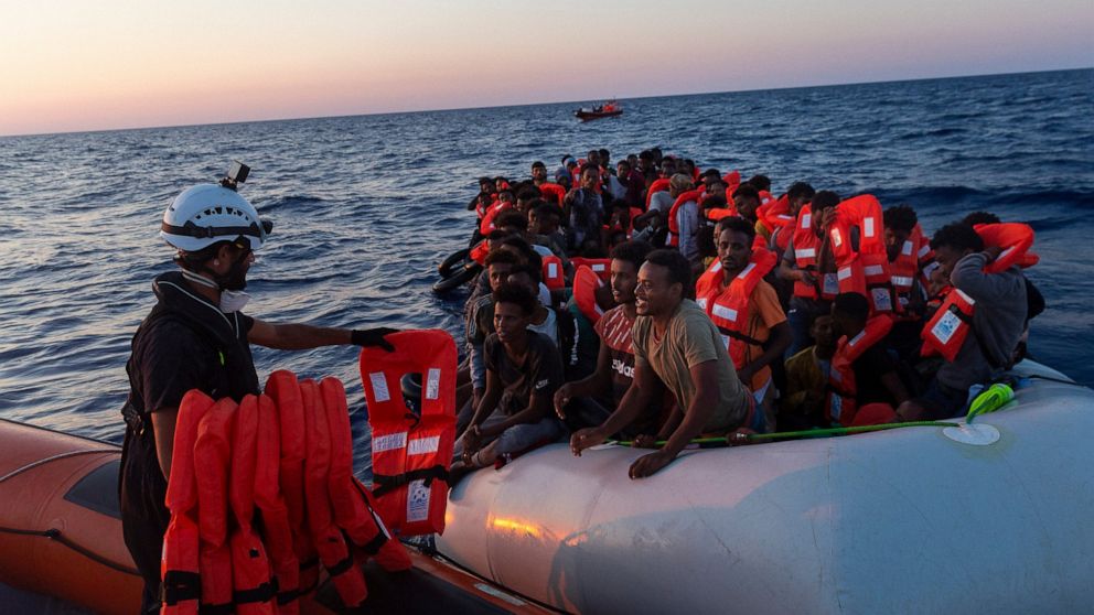 Crew of the Sea-Watch 3 distribute life jackets to 108 people in a boat in distress in the central Mediterranean on Saturday, July 23, 2022. Ships in the Mediterranean Sea have rescued over 1,100 people struggling to reach Europe in rickety smugglers