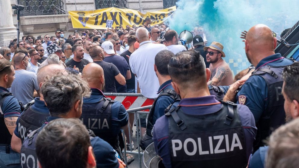 Hundreds of taxi drivers protest in front of Chigi Palace government offices in Rome, Wednesday, July 13, 2022. Taxi drivers left their cars idle for a second day to protest the Italian government's plans to allow more competition, including share-ri