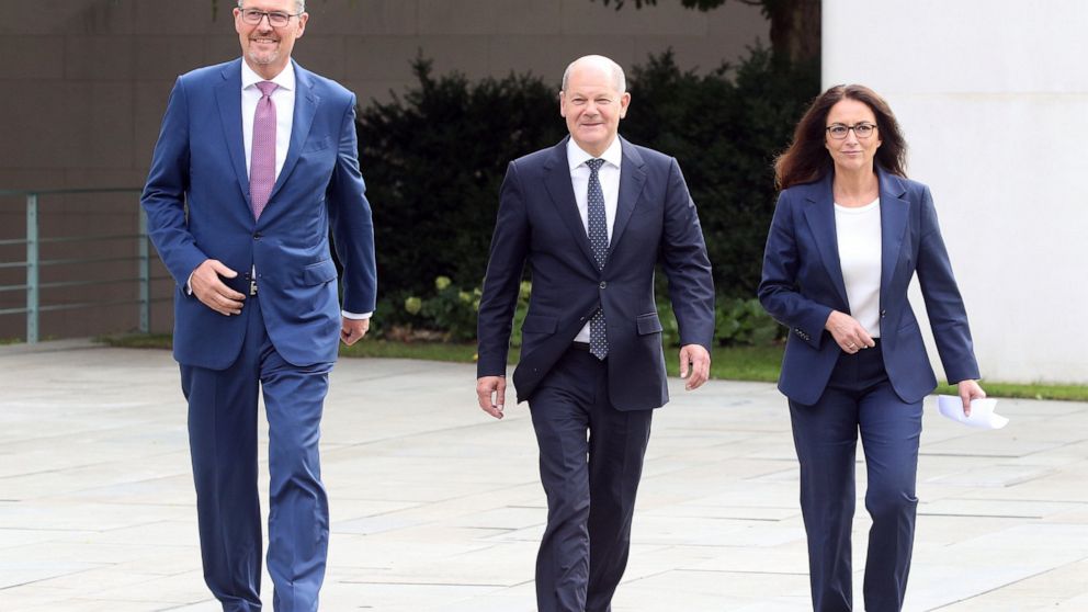 Yasmin Fahimi, Chairwoman of the German Trade Union Confederation, right, Chancellor Olaf Scholz, center, and Rainer Dulger, BDA President, go to make a statement after a Concerted Action meeting in the Chancellor's Office in Berlin, Germany, Thursda