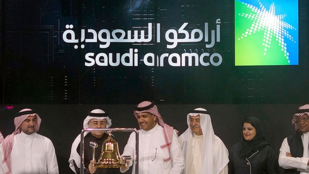 FILE - In this Dec. 11, 2019, file photo, Saudi Arabia's state-owned oil company Armco and stock market officials celebrate during the official ceremony marking the debut of Aramco's initial public offering (IPO) on the Riyadh's stock market, in Riya