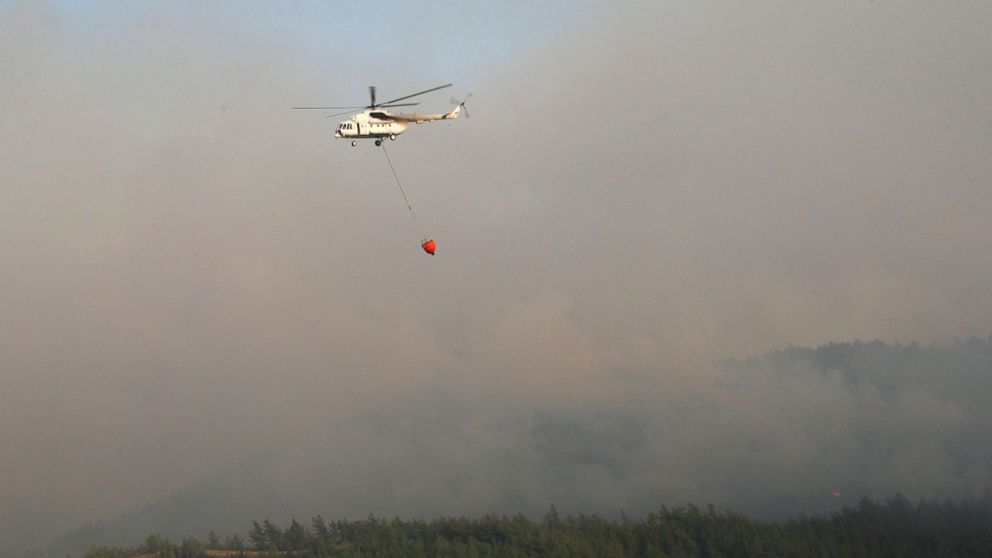 A water-dropping aircraft flies over the Bordubet region, near Marmaris, western Turkey, Thursday, June 23, 2022. Water-dropping aircraft from Azerbaijan and Qatar on Friday joined the fight against a wind-stoked wildfire that burned for a fourth day