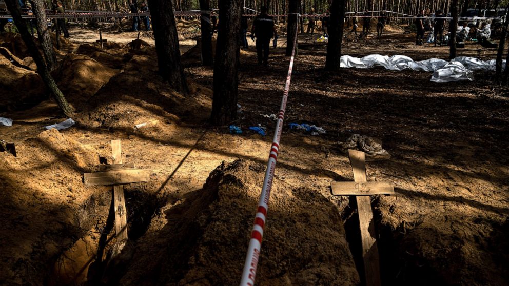Unidentified graves of civilians and Ukrainian soldiers in a cemetery during an exhumation in the recently retaken area of Izium, Ukraine, Saturday, Sept. 17, 2022. Ukrainian authorities discovered a mass burial site near the recaptured city of Izium