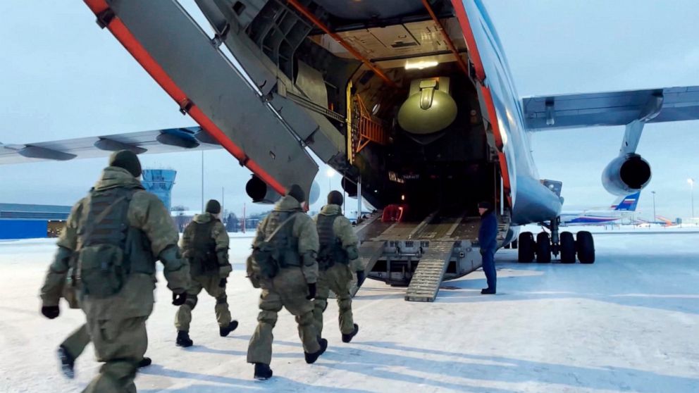 In this photo taken from video released by the Russian Defense Ministry Press Service, Russian peacekeepers board on a Russian military plane at an airfield outside Moscow, in Russia to fly to Kazakhstan Thursday, Jan. 6, 2022. A Russia-led military 