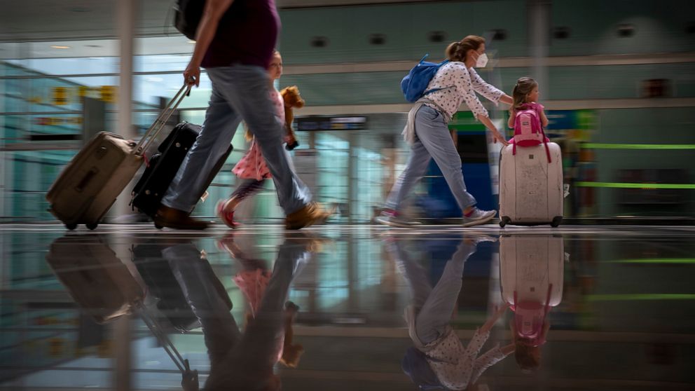 FILE -, tourists arrive at Barcelona airport, Spain, Monday, June 7, 2021. European Union member countries agree they should further facilitate tourist travel into the 27-nation bloc for people who are vaccinated against the coronavirus or have recov