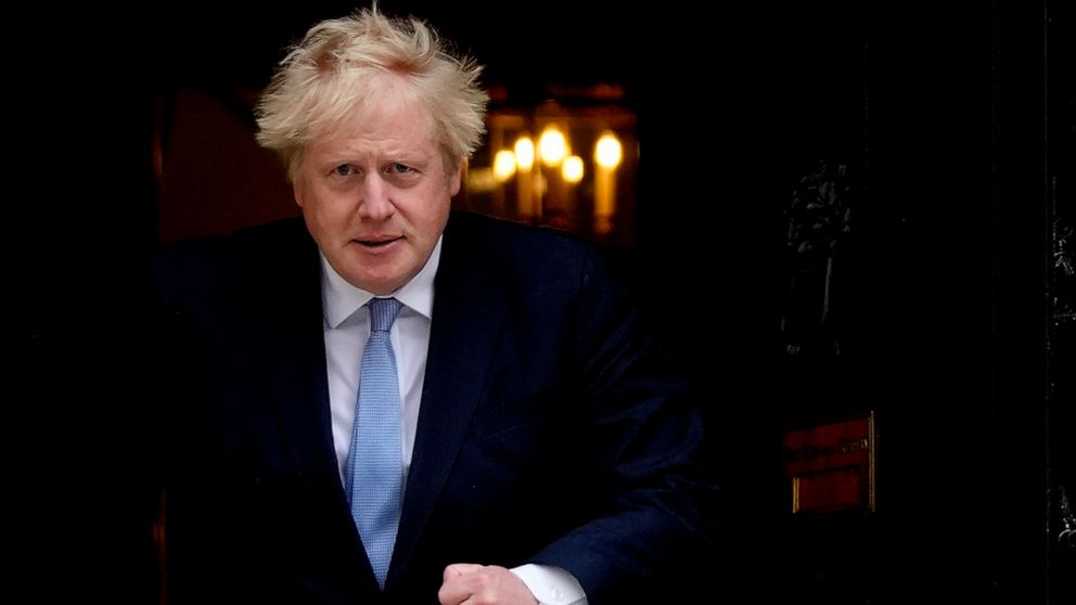 FILE - Britain's Prime Minister Boris Johnson walks out the door to meet Norwegian Prime Minister Jonas Gahr Store at 10 Downing Street in London, Friday, May 13, 2022. Johnson is heading to Northern Ireland on Monday, May 16, 2022 to try to end a po