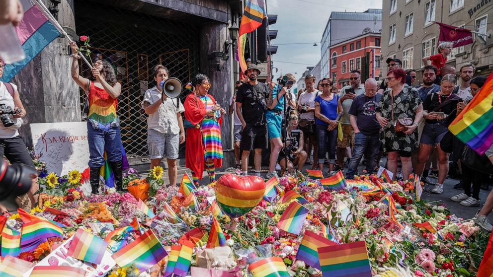 Flowers are left as a spontaneous pride parade arrives at the scene of a shooting in central Oslo, Saturday, June 25, 2022. Norwegian police say they are investigating an overnight shooting in Oslo that killed two people and injured more than a dozen