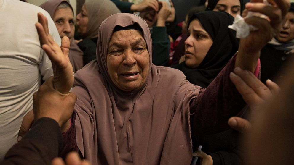 A mourner cries after taking the last look at the body of Atta Shalabi at the family house during his funeral in the West Bank town of Qabatiya, south of Jenin, Thursday, Dec. 8, 2022. Israeli forces killed Palestinians Atta Shalabi, Tarek al-Damj, a