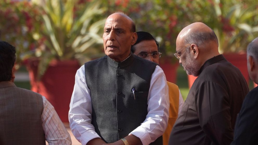 Indian Defence Minister Rajnath Singh, center, and Home Minister Amit Shah, right, talk to their cabinet colleagues as they wait to pay respect to the victims of 2001 terror attack on Parliament House, in New Delhi, Tuesday, Dec. 13, 2022. Soldiers f