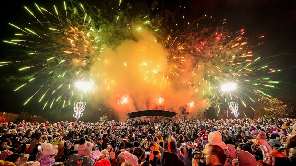 Fireworks light the sky at a Christmas fair which opened ahead of the holiday season in Bucharest, Romania, Friday, Nov. 25, 2022. (AP Photo/Andreea Alexandru)