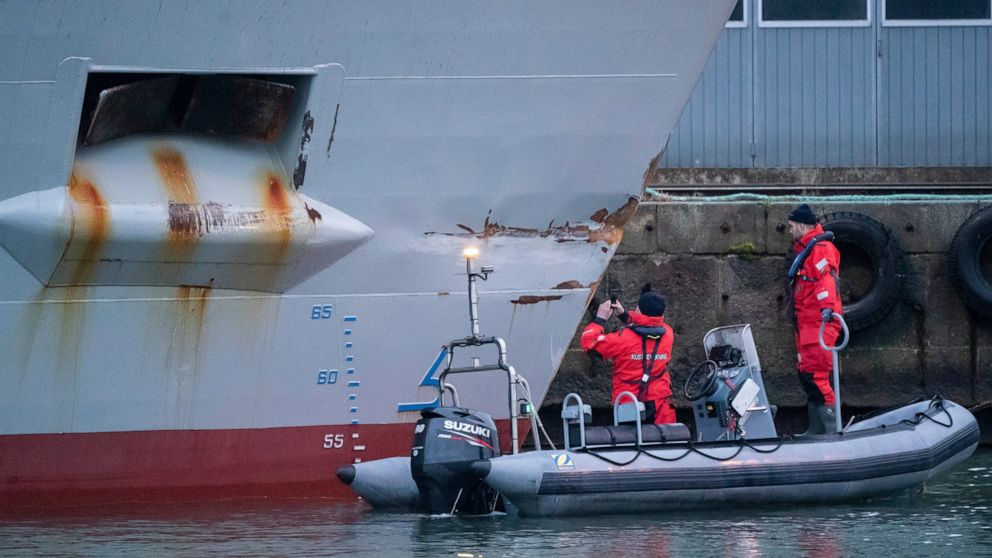Personnel from the Swedish Coast Guard investigate the damaged ship Scot Carrier in the port of Ystad, Sweden, Tuesday, Dec. 14, 2021. Two cargo ships - the Danish Karin Hoej and the British Scot Carrier - collided in the Baltic sea between the Swedi