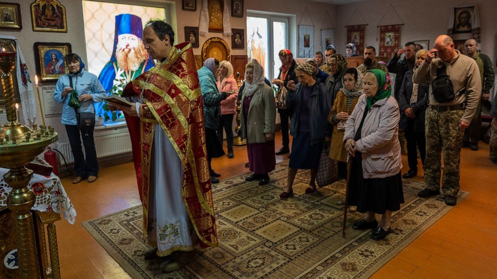 Ukrainian Army chaplain Vasyl celebrates a Sunday mass at a Ukrainian Orthodox church in Kharkiv, eastern Ukraine, Sunday, May 29, 2022. (AP Photo/Bernat Armangue)