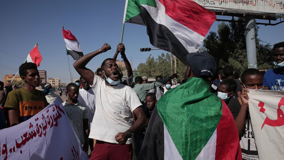 Thousands of protesters take to the streets to renew their demand for a civilian government in the Sudanese capital Khartoum, Thursday, Nov. 25, 2021. The rallies came just days after the military signed a power-sharing deal with the prime minister, 