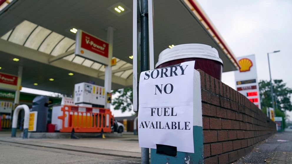 A view of a sign at a petrol station, in Bracknell England, Sunday Sept. 26, 2021. In a U-turn, Britain says it will issue thousands of emergency visas to foreign truck drivers to help fix supply-chain problems that have caused empty supermarket shel