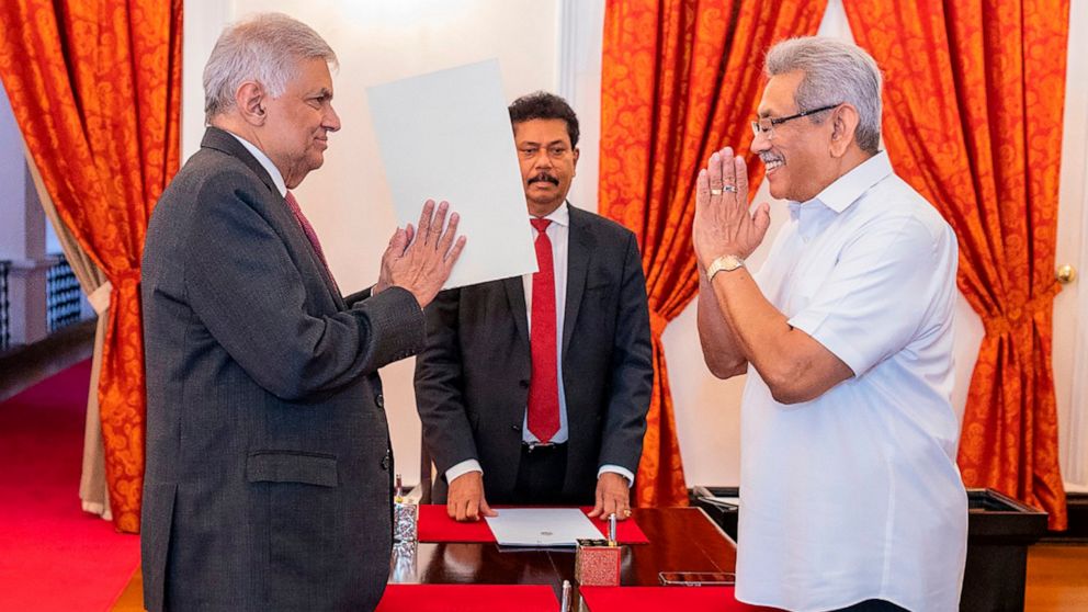 FILE- In this photograph provided by the Sri Lankan President's Office, President Gotabaya Rajapaksa, right, greets prime minister Ranil Wickremesinghe during the latter's oath taking ceremony as the new finance minister in Colombo, Sri Lanka, May 25