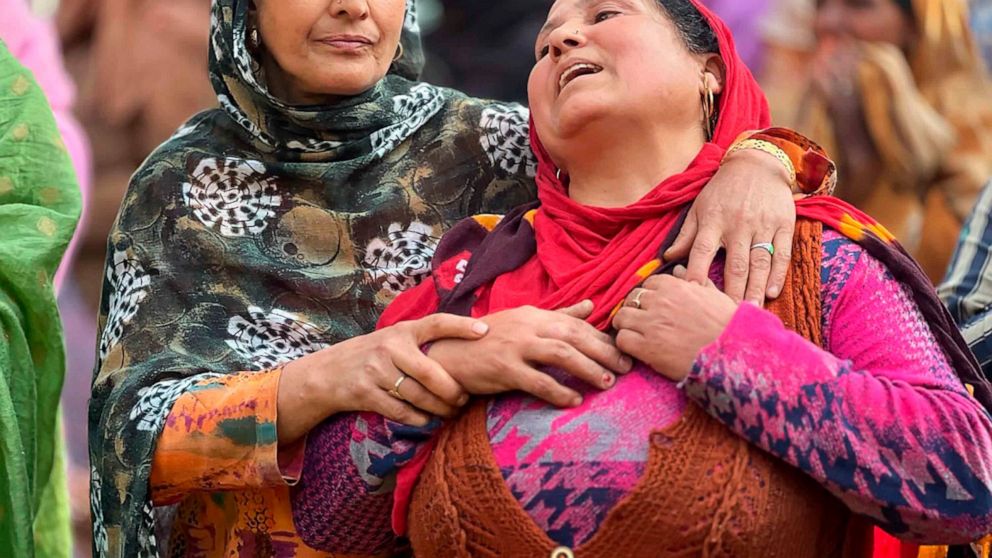 A woman mourns the killing of her brother-in-law Puran Krishan Bhat, who is from the minority community of Kashmiri Hindus, outside his home in in southern Shopian district, Indian controlled Kashmir, Saturday, Oct. 15, 2022. Assailants on Saturday f