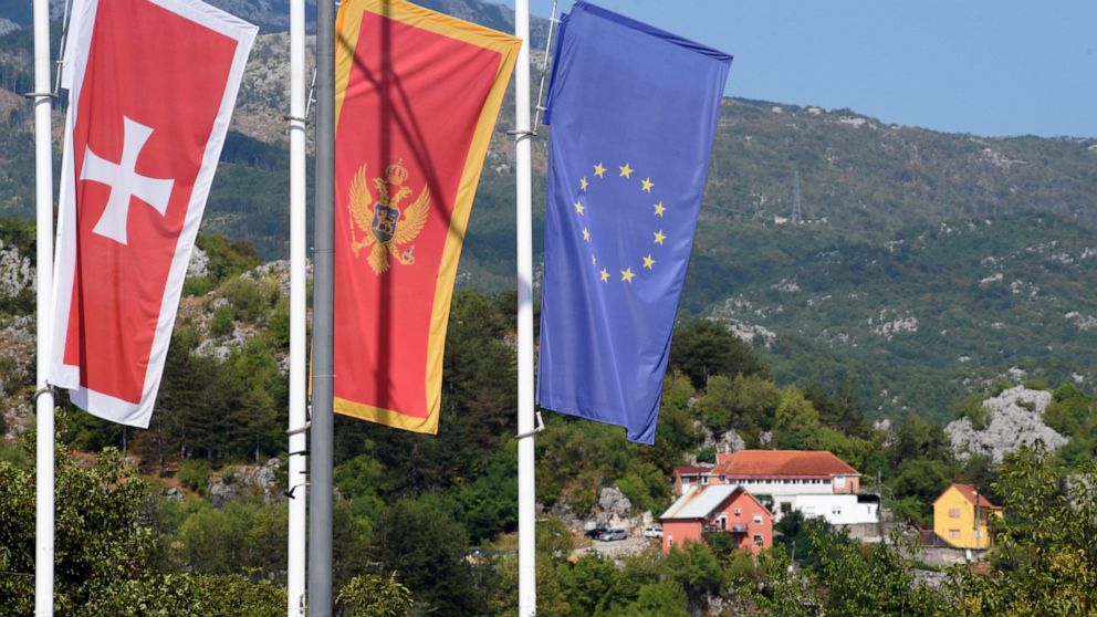 Flags flew at half-mast in front of the site of the attack in Cetinje, some 30 km west of Podgorica, Montenegro, Saturday, Aug. 13, 2022. A man went on a shooting rampage in the streets of a western Montenegro city Friday, killing multiple people, be