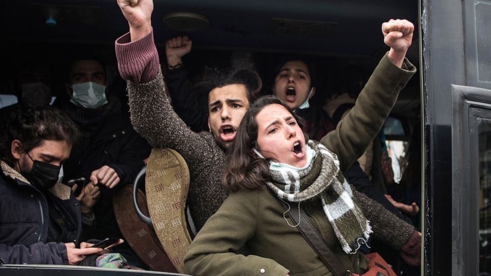 Students chant slogans from inside a police van after they were detained during a rally outsider a courthouse in Istanbul, Friday, March 26, 2021. Turkish police detained dozens of people who assembled in a show of solidarity with 12 students who wer