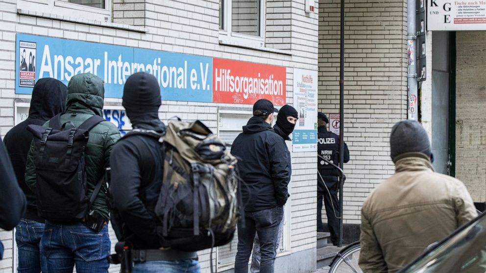 Police officers stay in front of a building of the Ansaar International association in Duesseldorf, Germany, Wednesday, May 5. 2021. The German government on Wednesday banned the Muslim organization. Buildings in 10 German states were raided, accordi