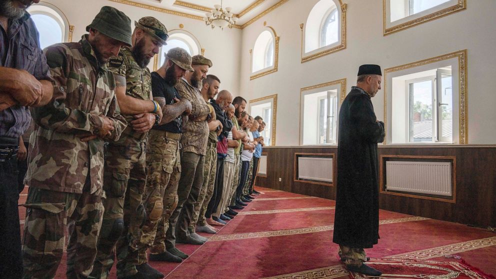 Former Mufti Sheikh Said Ismahilov, leads Muslim soldiers during prayers on the first day of Eid al-Adha, in Medina Mosque, Konstantinovka, eastern Ukraine, Saturday, July 9, 2022. Muslims around the world celebrate Eid al-Adha by sacrificing animals