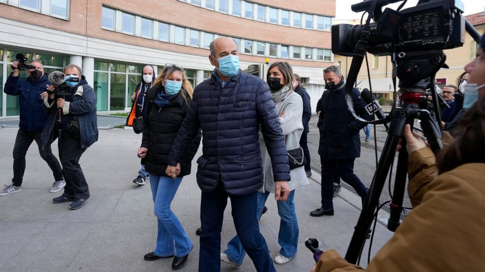 Enzo Garzarella, right, father of Umberto killed in a boat collision on lake Garda, arrives at Brescia's court, northern Italy, Wednesday, Nov. 10, 2021. The trial starts for two German nationals accused of having caused a boat collision on lake Gard