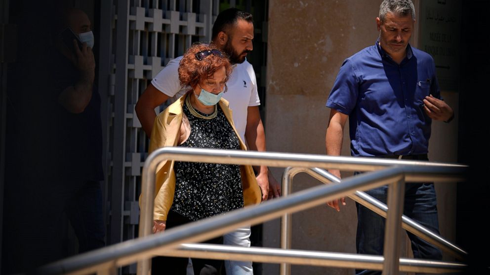 Lebanese Judge Ghada Aoun, left, leaves the Central Bank following a raid to pursue embattled Central Bank Governor Riad Salameh on corruption charges in Beirut, Lebanon, Tuesday, July 19, 2022. (AP Photo/Bilal Hussein)
