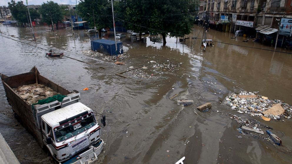 A truck drives through a flooded road after a heavy rainfall in Karachi, Pakistan, Monday, July 11, 2022. The death toll from rain-related incidents over the past month has risen to over 140 as monsoon rains continue to lash Pakistan, triggering flas