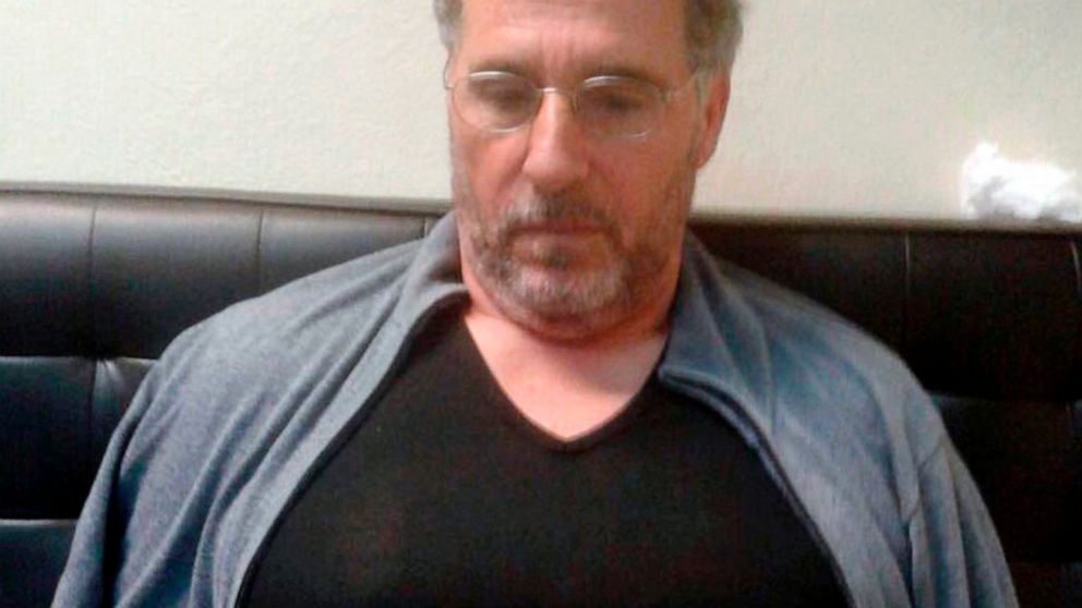 FILE - In this Sept. 3, 2017 file photo released by the Italian police, a man identified by police as longtime fugitive Rocco Morabito, looks down after being arrested at a hotel in Montevideo, Uruguay. A convicted Italian mobster, one of Italy's mos