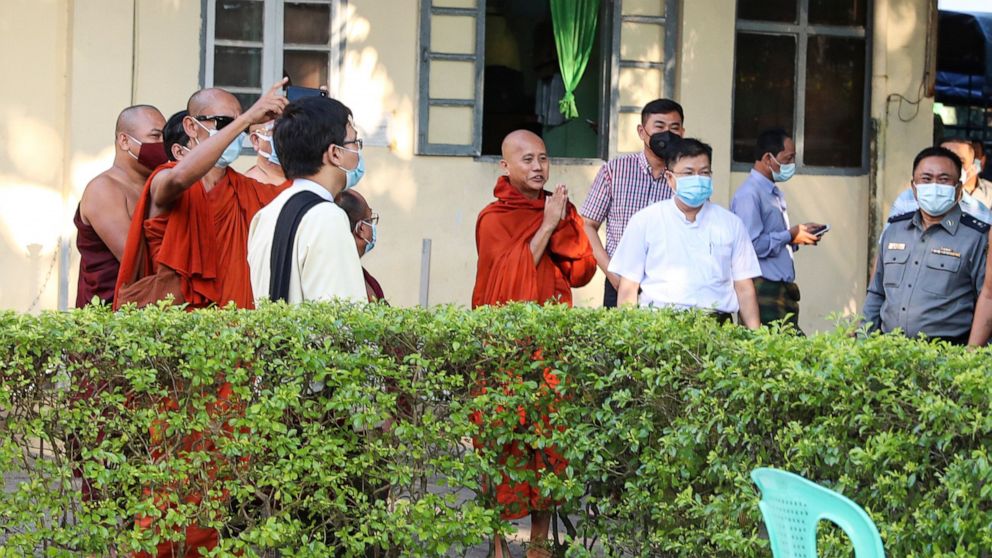Buddhist monk Wirathu, center, gestures to his followers at a police station in Yangon, Myanmar, Monday Nov. 2, 2020. Wirathu, a nationalist Buddhist monk in Myanmar noted for his inflammatory rhetoric, has surrendered to police, who have been seekin