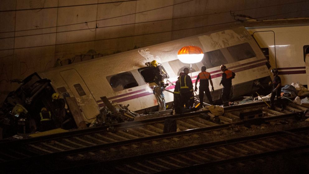 FILE - Emergency personnel work at the site of a train which was derailed in Santiago de Compostela, Spain, on Thursday, July 25, 2013. A trial has begun in Spain on Wednesday Oct. 5, 2022 for the 2013 train accident that killed 80 passengers and inj