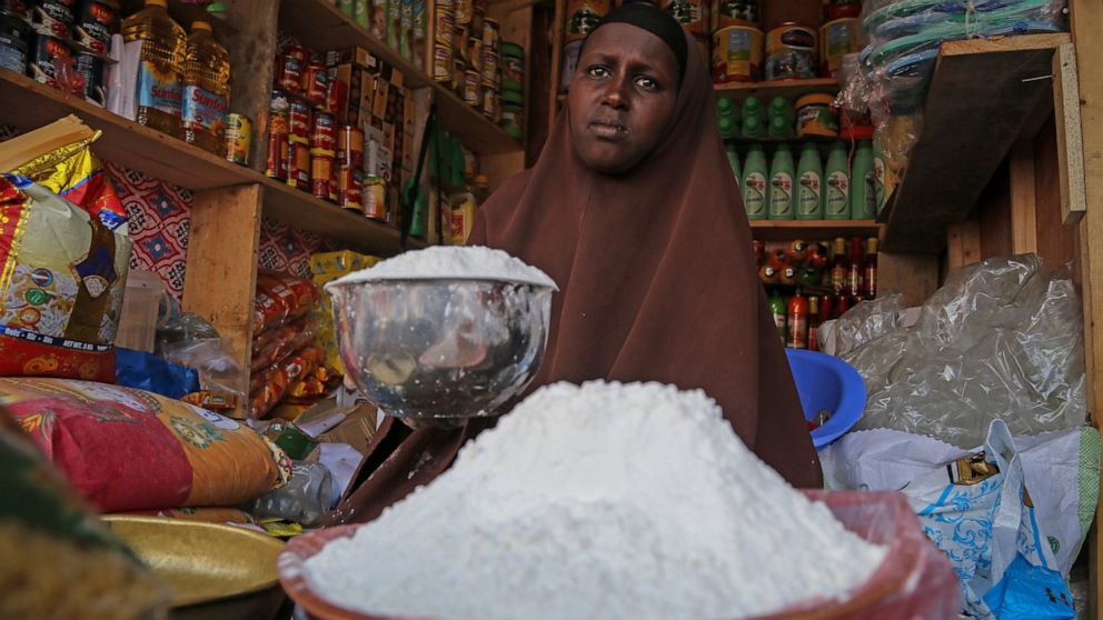 FILE - A shopkeeper sells wheat flour in the Hamar-Weyne market in the capital Mogadishu, Somalia on May 26, 2022. "Africa is actually taken hostage" in Russia's invasion of Ukraine amid catastrophically rising food prices, Ukrainian President Volody