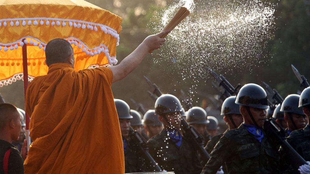 A Buddhist monk splashes holy water to Thai soldiers during the Royal Thai Armed Forces Day ceremony at a military base in Bangkok, Thailand, Friday, Jan. 18, 2019. (AP Photo/Sakchai Lalit)