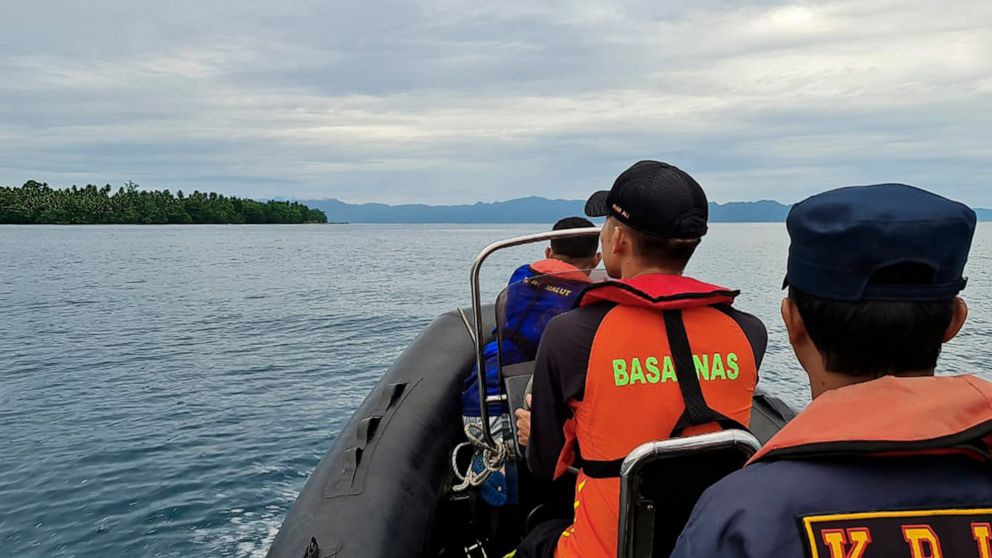 In this photo released by the National Search and Rescue Agency (BASARNAS), rescuers on a rubber boat scans the horizon as they search survivors after a passenger boat KM Cahaya Arafah sank in the waters off South Halmahera district in North Maluku, 