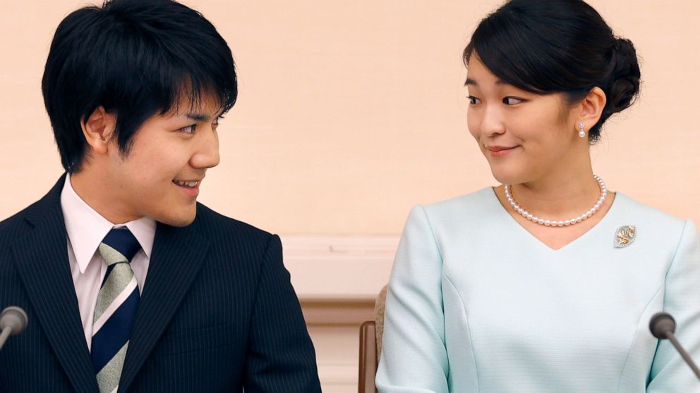 FILE - Japan's Princess Mako and her fiance Kei Komuro look at each other during a press conference at Akasaka East Residence in Tokyo on Sept. 3, 2017. Komuro has passed the New York bar exam, defying detractors back home who had criticized their ro