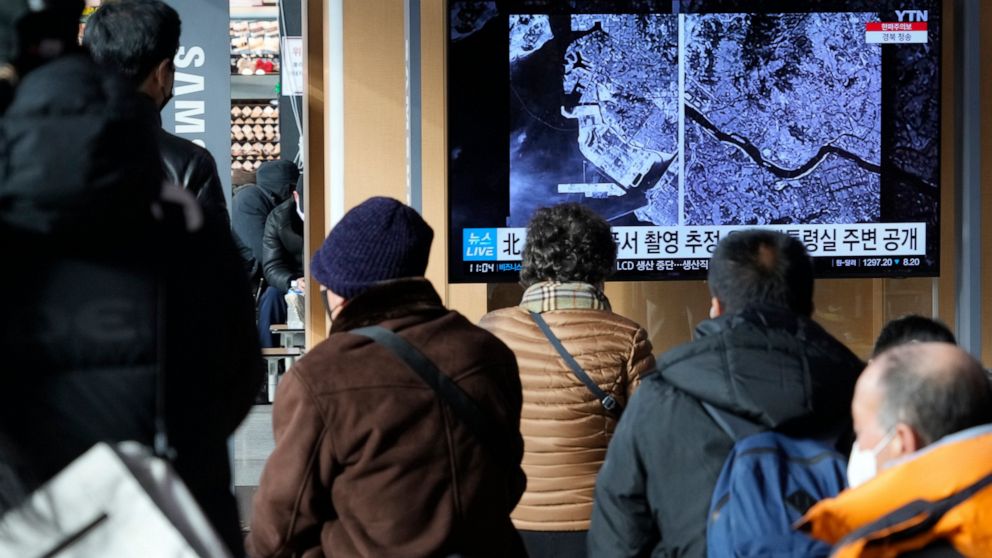 A TV screen shows images showing a space view of the South Korean capital and Incheon, left, during a news program at the Seoul Railway Station in Seoul, South Korea, Monday, Dec. 19, 2022. North Korea said Monday it fired a test satellite in an impo