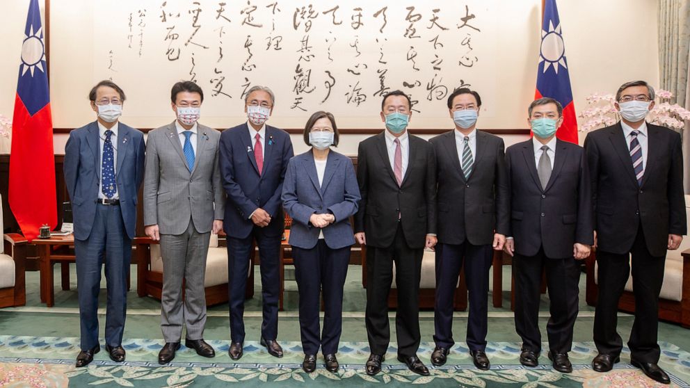 In this photo released by the Taiwan Presidential Office, Taiwan's President Tsai Ing-wen, center left, poses for photos with a delegation from Japan, in Taipei, Taiwan on Tuesday, Aug. 23, 2022. Taiwan's president invoked an armed conflict from 1958