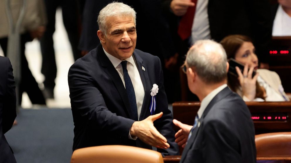 Israeli outgoing Prime Minister Yair Lapid is seen during the swearing-in ceremony for Israeli lawmakers at the Knesset, Israel's parliament, in Jerusalem, Tuesday, Nov. 15, 2022. Israeli lawmakers were sworn in at the Knesset, on Tuesday, following 
