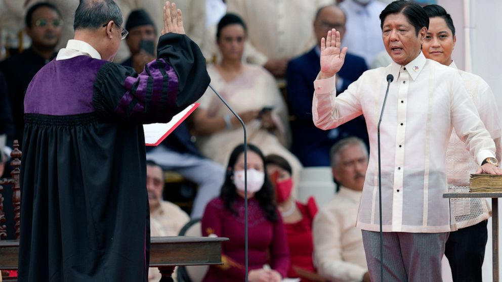 President-elect Ferdinand "Bongbong" Marcos Jr., right, is sworn in by Supreme Court Chief Justice Alexander Gesmundo during the inauguration ceremony at National Museum on Thursday, June 30, 2022 in Manila, Philippines. Marcos was sworn in as the co