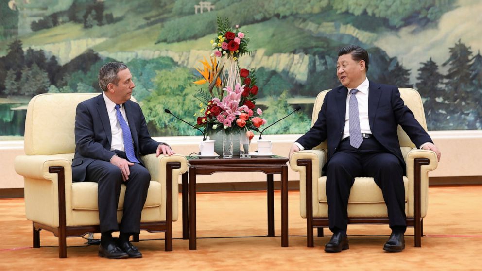 FILE - In this March 20, 2019, file photo, Chinese President Xi Jinping, right, meets with Harvard University President Lawrence Bacow at the Great Hall of the People in Beijing. An intensive summer language program hosted by Harvard University in Be