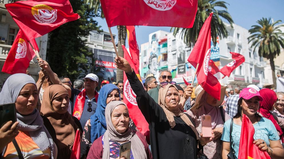 Supporters of the Tunisian General Labor Union (UGTT) gather during a rally outside its headquarters in Tunis, Tunisia, Thursday, June 16, 2022. A nationwide public sector strike in Tunisia is poised to paralyze land and air transportation and other 