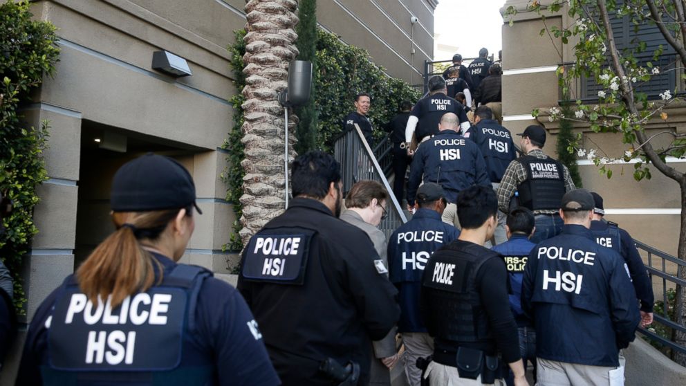 FILE - In this March 3, 2015 file photo, federal agents enter an upscale apartment complex where authorities say a birth tourism business charged pregnant women $50,000 for lodging, food and transportation, in Irvine, Calif. On Thursday, Jan. 31, 201